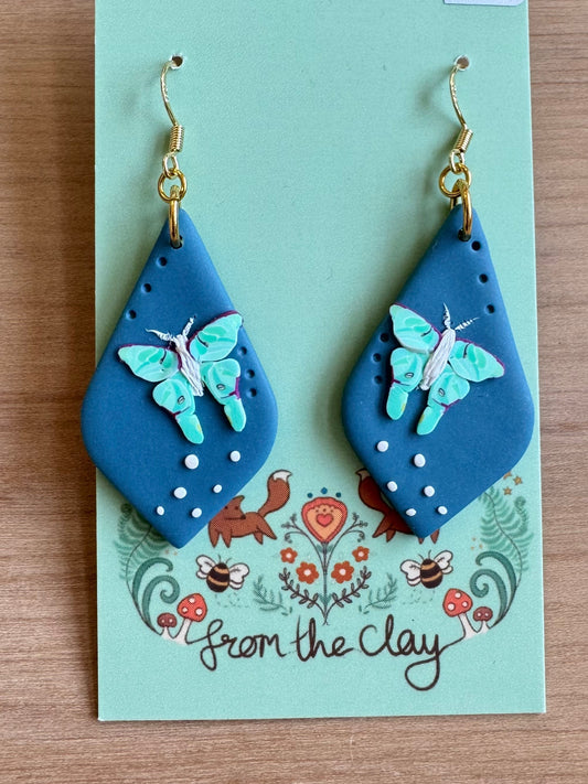 Blue teardrop earrings with flying Luna Moth made entirely of polymer clay.