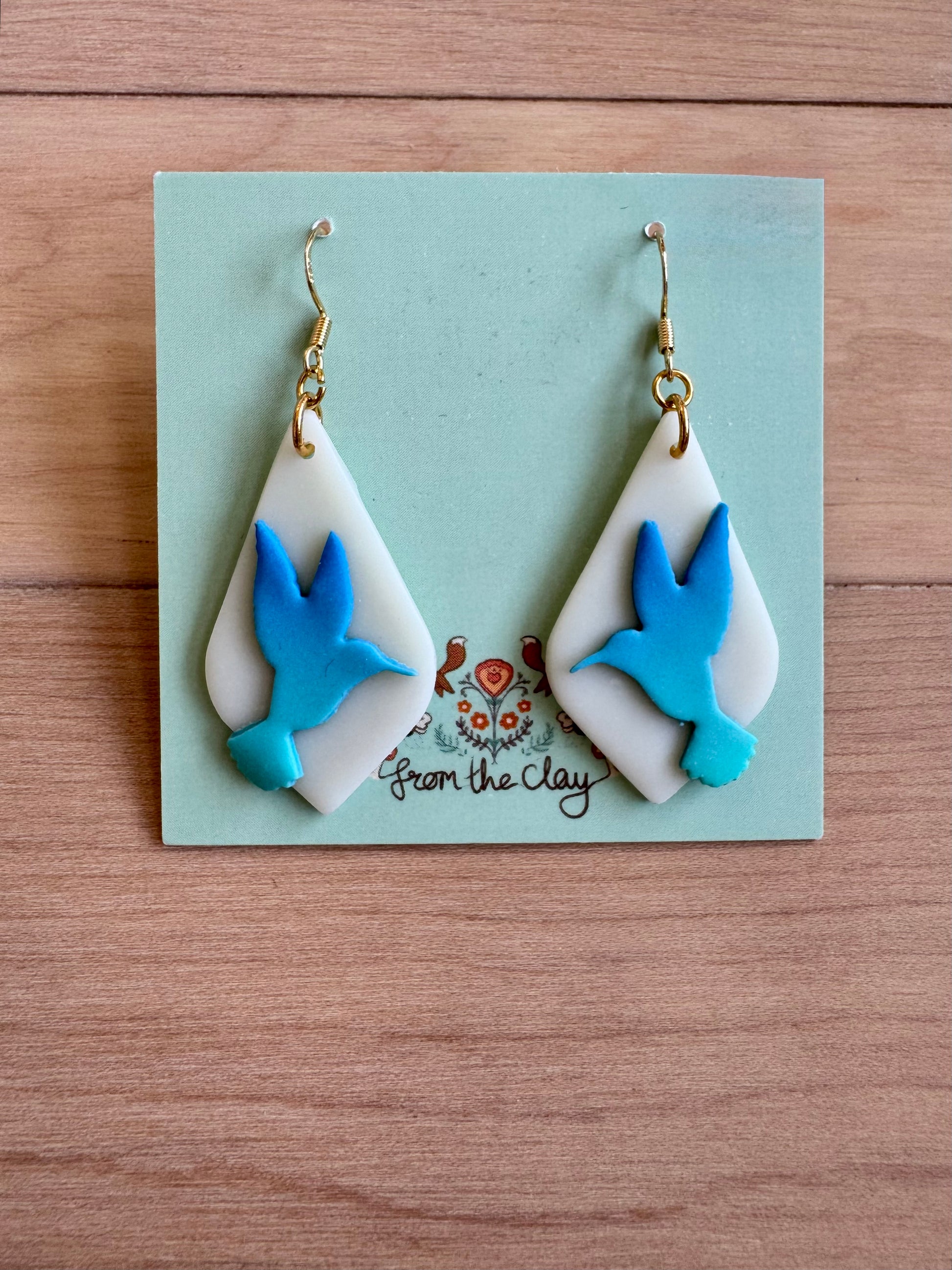 Ombre blue hummingbirds on a light white almost translucent drop earrings 